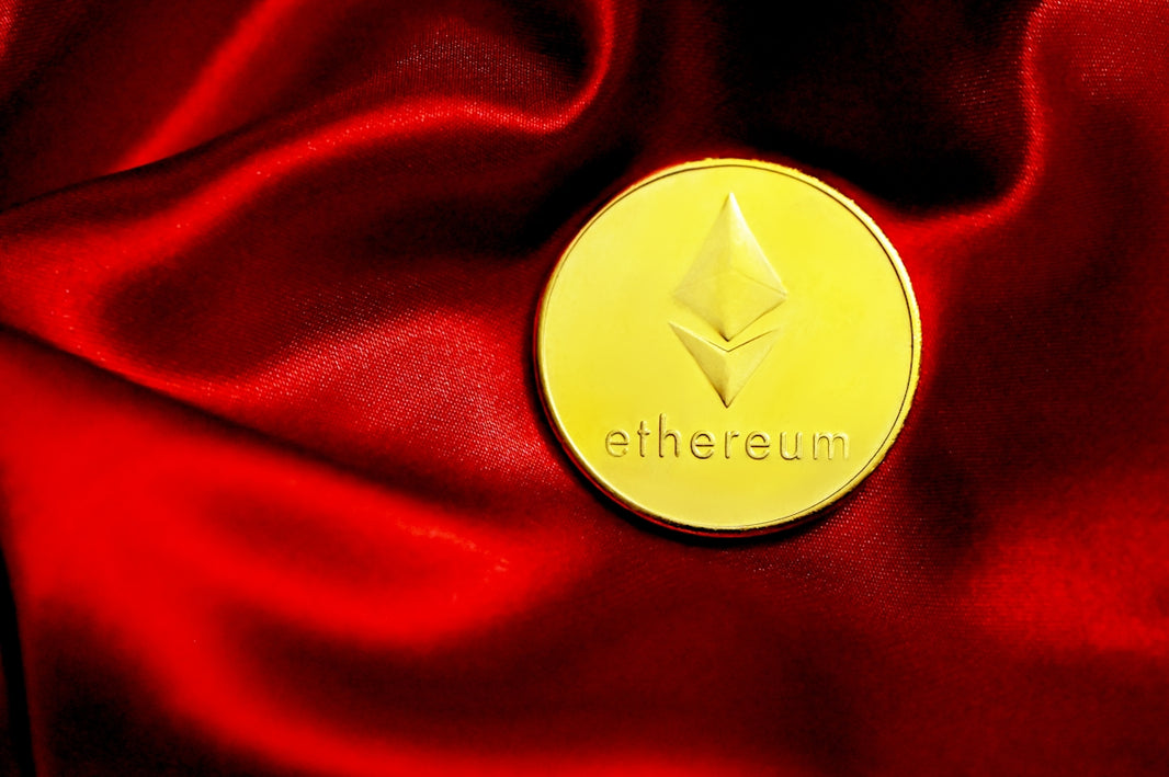 a close up of a red cloth with a gold coin